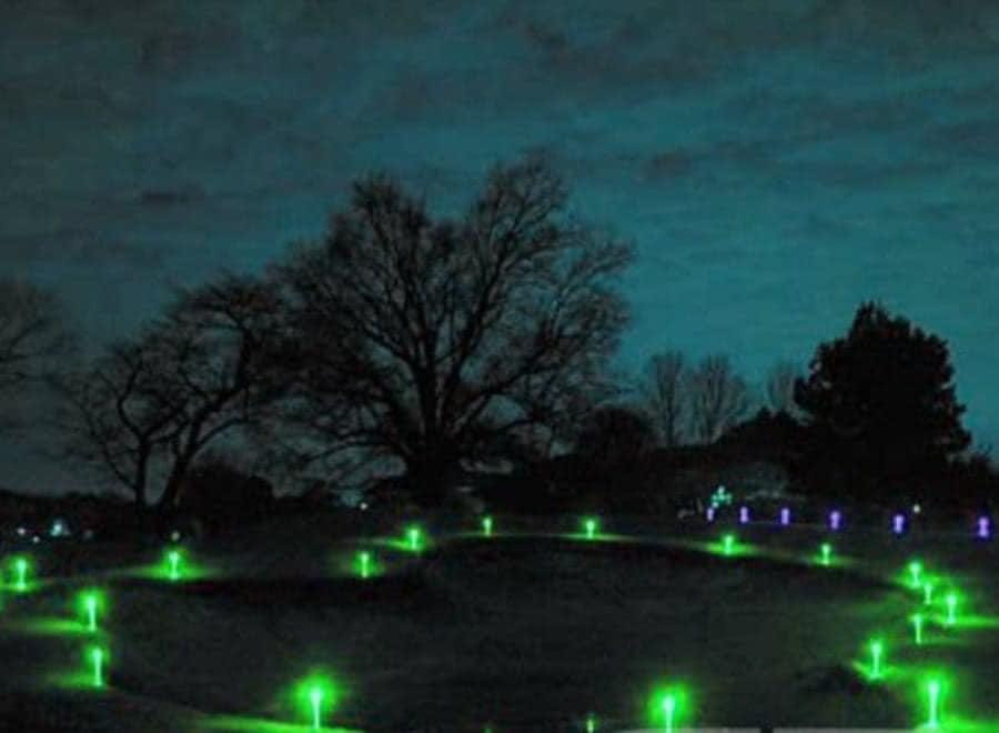 glow golf green surrounded by glowsticks