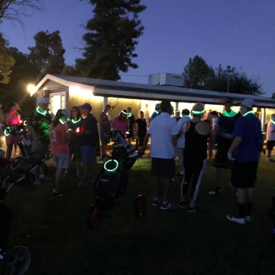 glow golf people gathered before round